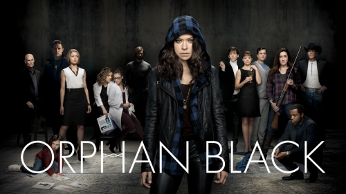 A cast of people spread out in a dark room, the words "Orphan Black" written over the image.